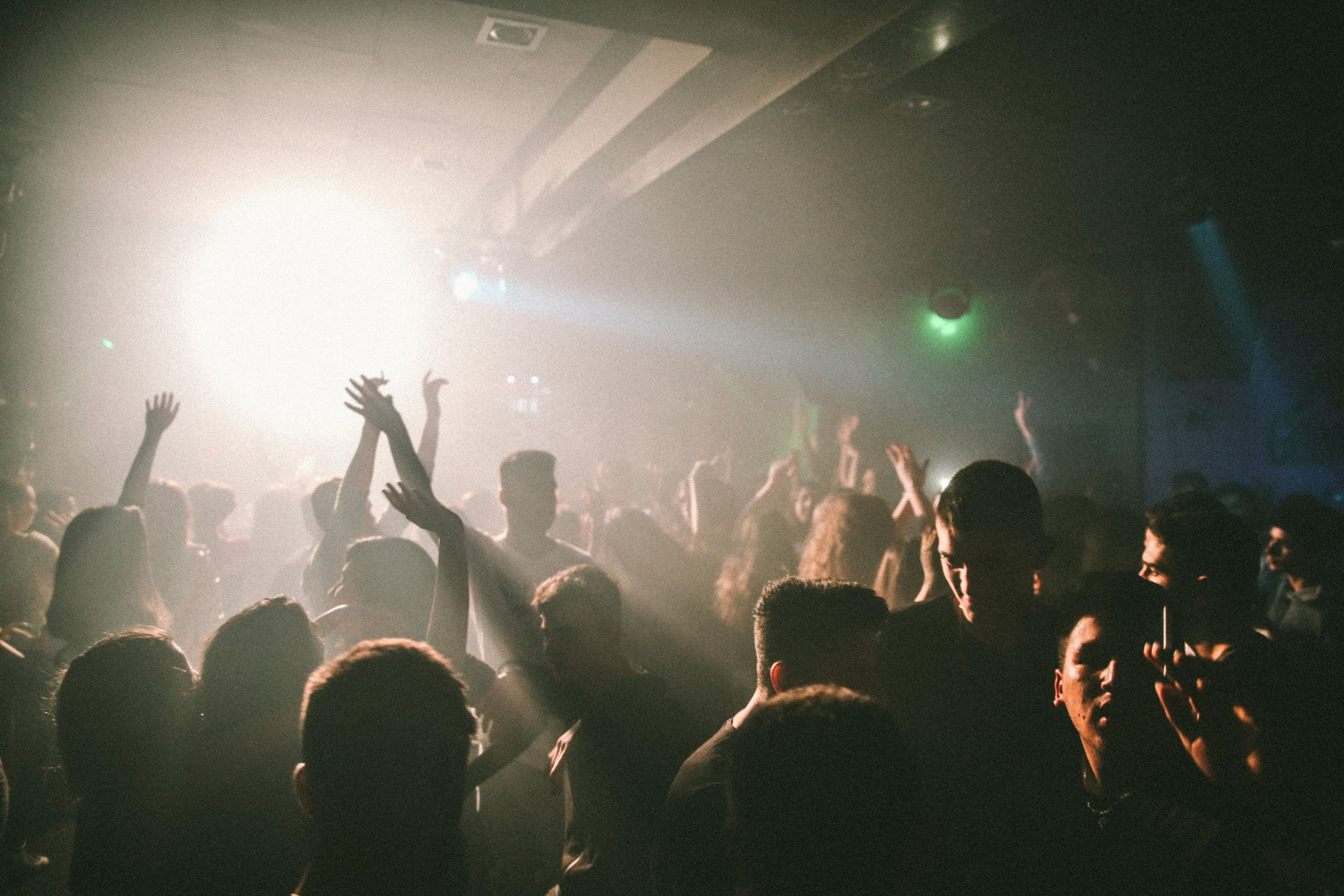 photo: dancers mid-move, backlit, dance floor haze